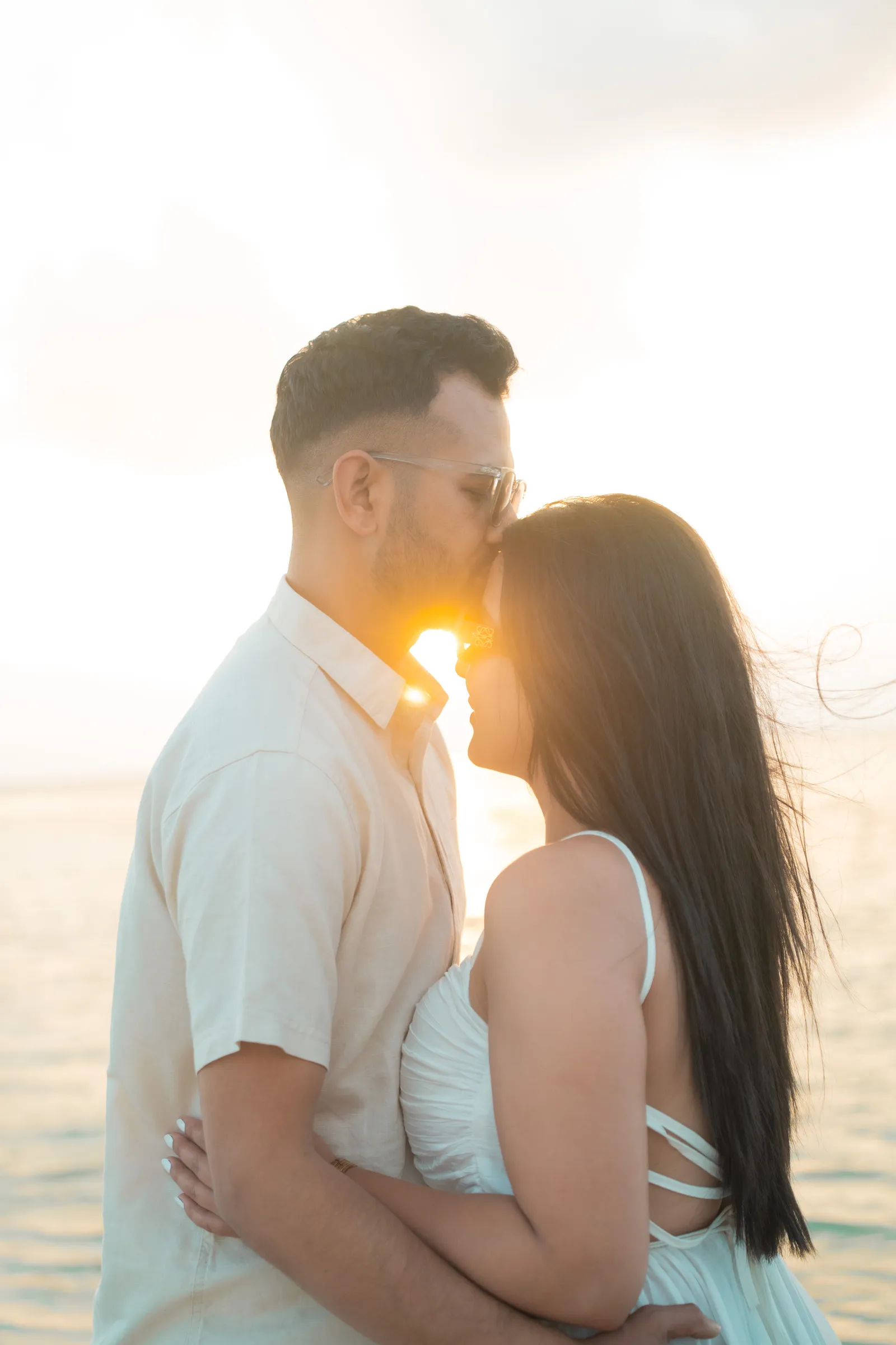 Couple kissing against the setting sun